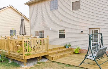 Elevated deck construction with stairs and safety railings Elevated deck construction with stairs and safety railings